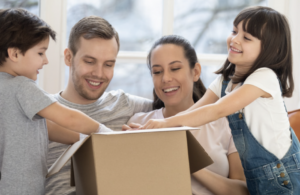 A parent enjoying stress-free parenting while unboxing The Baby Box essentials.